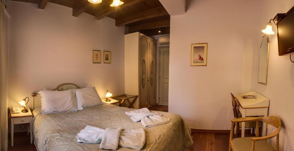 Postel nebo postele na pokoji v ubytování Palazzo Duca