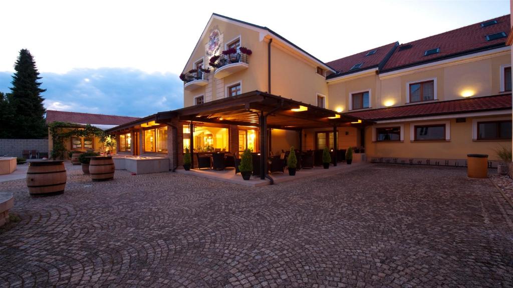 a large building with a courtyard in front of it at Hotel Princess in Lednice