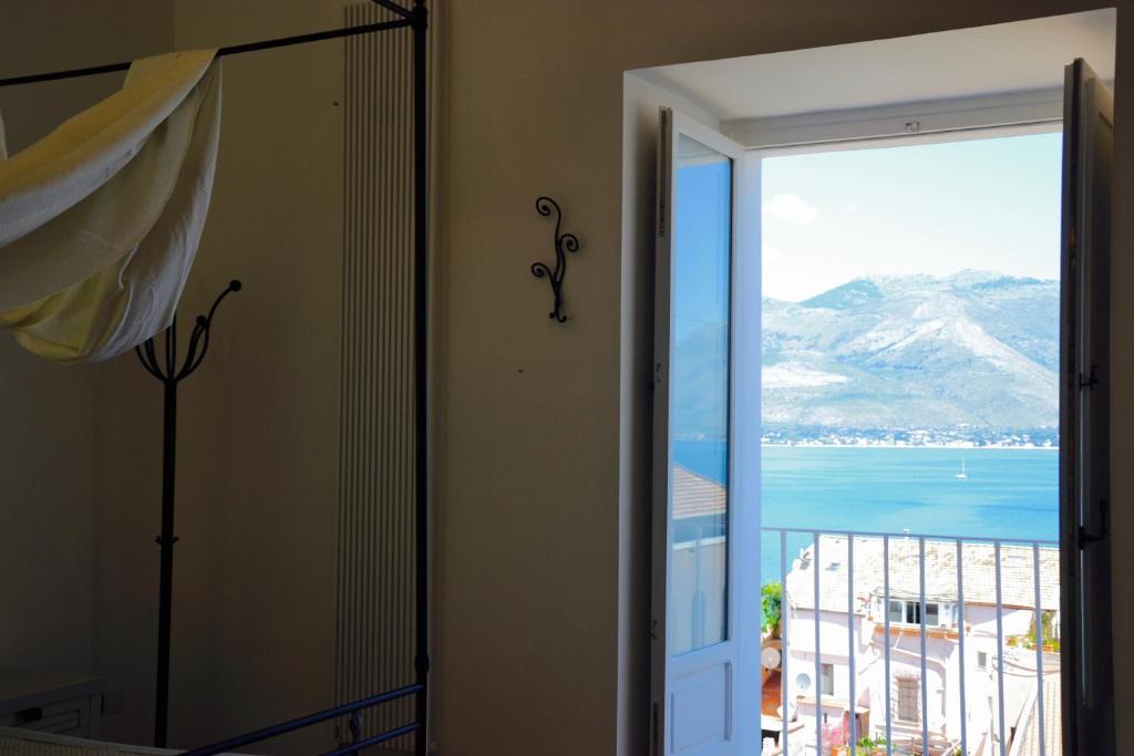 a bedroom with a door open to a view of the ocean at Il Bottone al Duomo in Gaeta