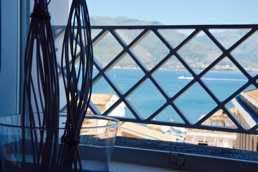 a glass vase sitting on a window sill with a view at Il Bottone al Duomo in Gaeta