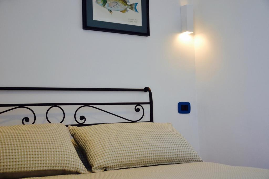 a bedroom with a bed with a picture on the wall at Il Bottone al Duomo in Gaeta