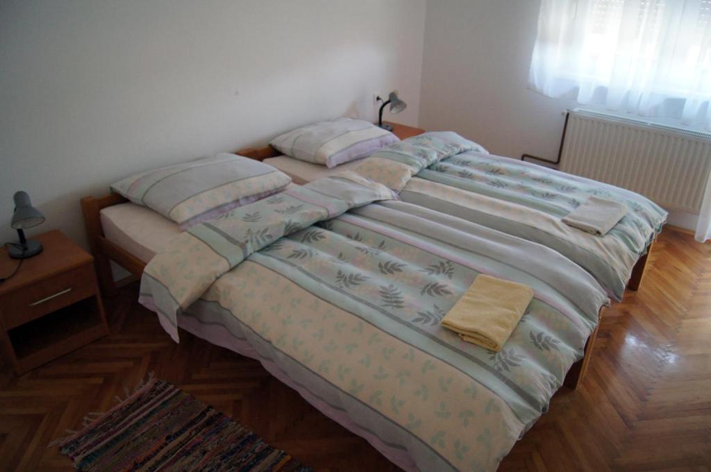 a bed with two pillows on it in a bedroom at Guest House Stara Baranja in Kneževi Vinogradi