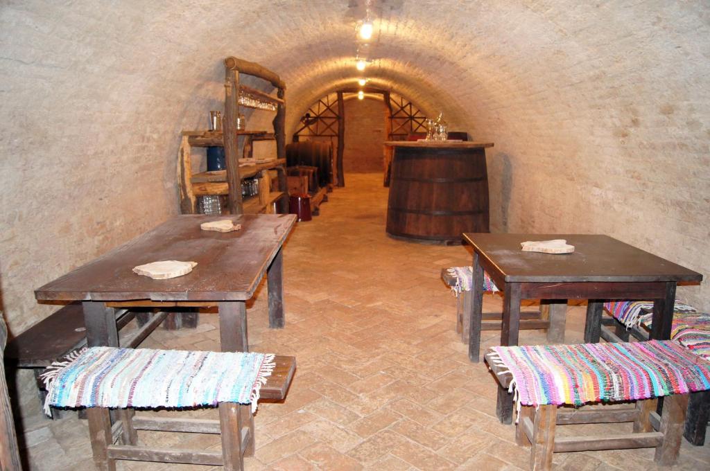 a room with tables and chairs in a tunnel at Guest House Stara Baranja in Kneževi Vinogradi