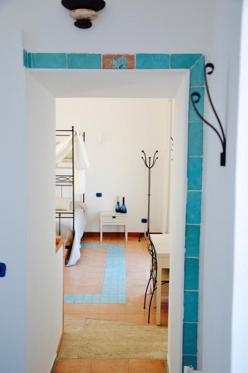 a living room with a blue tile wall and a table at Il Bottone al Duomo in Gaeta