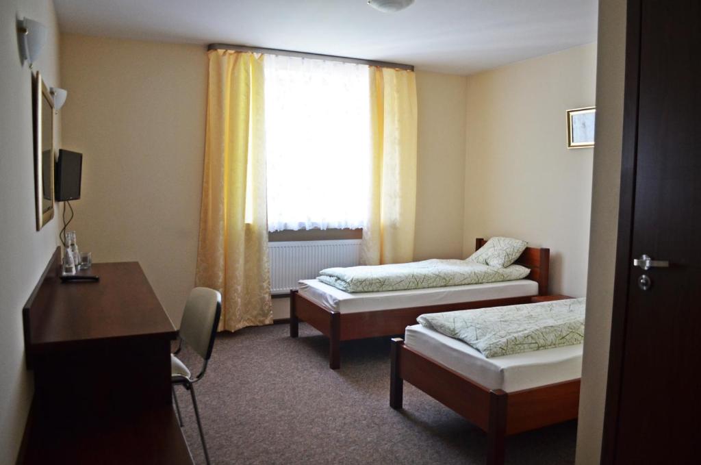 um quarto de hotel com duas camas e uma janela em Willa Sailor Pabianice em Pabianice