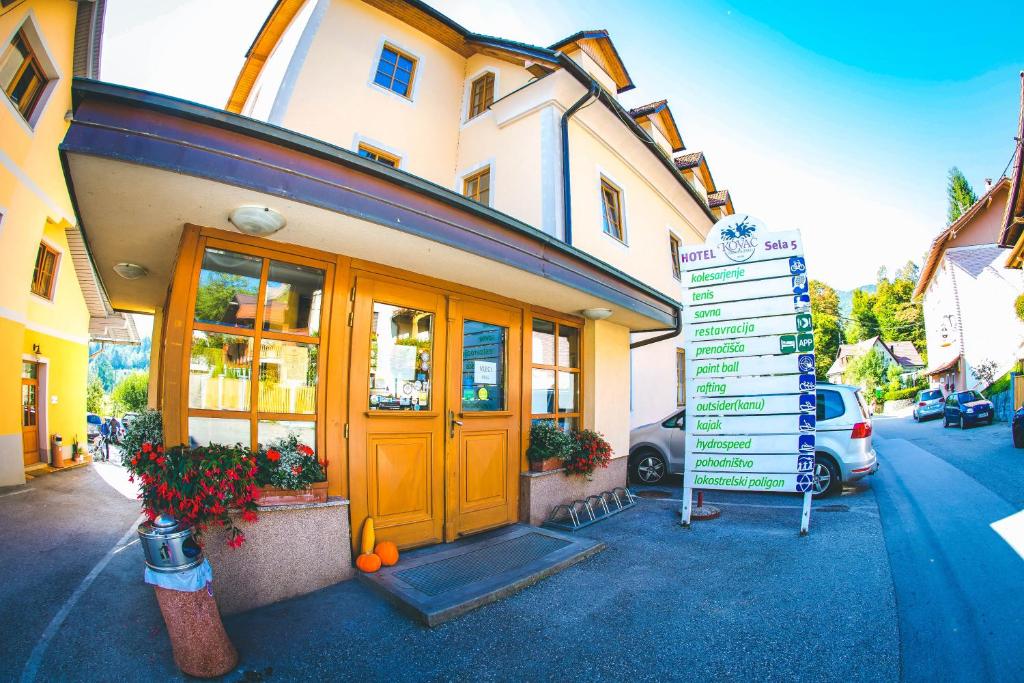 a building with a street sign in front of it at Hotel Kovac in Osilnica