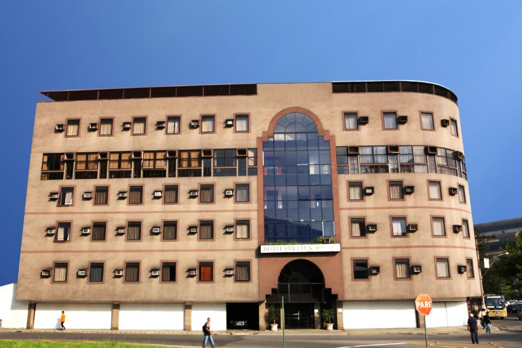 a large building with a large window at Stratus Vila Hotel in Volta Redonda