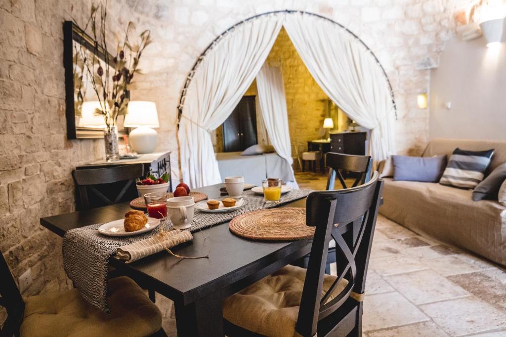 un salon avec une table sur laquelle est posée de la nourriture dans l'établissement Masseria Rosa Trulli Relais, à Alberobello