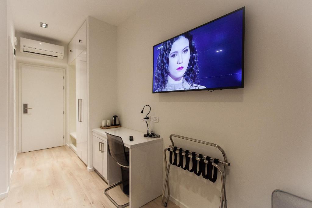 Televízia a/alebo spoločenská miestnosť v ubytovaní Priuli Luxury Rooms
