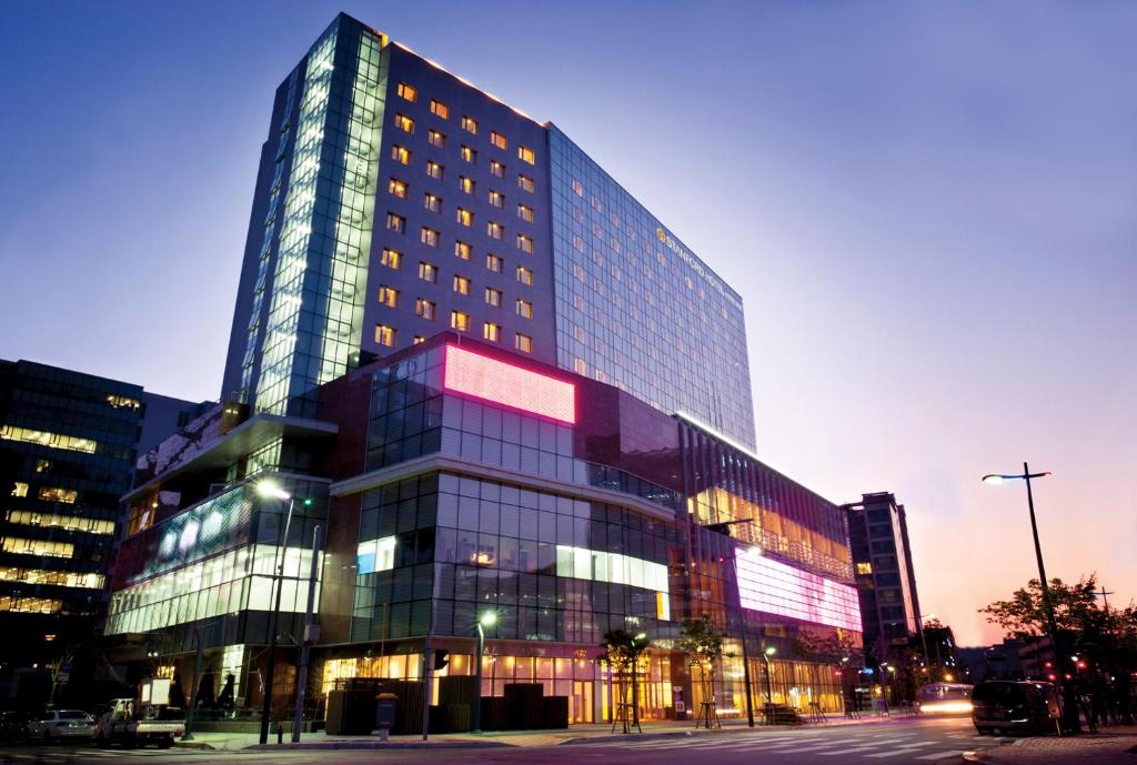 a large building with many windows in a city at Stanford Hotel Seoul in Seoul