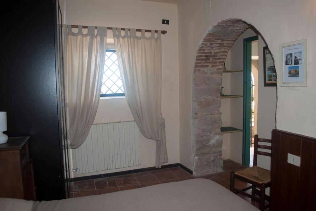 A bed or beds in a room at Agriturismo Fattoria di Grenne
