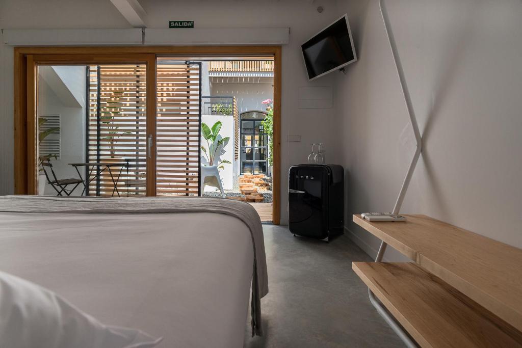 Postel nebo postele na pokoji v ubytování Sodium Boutique Hotel