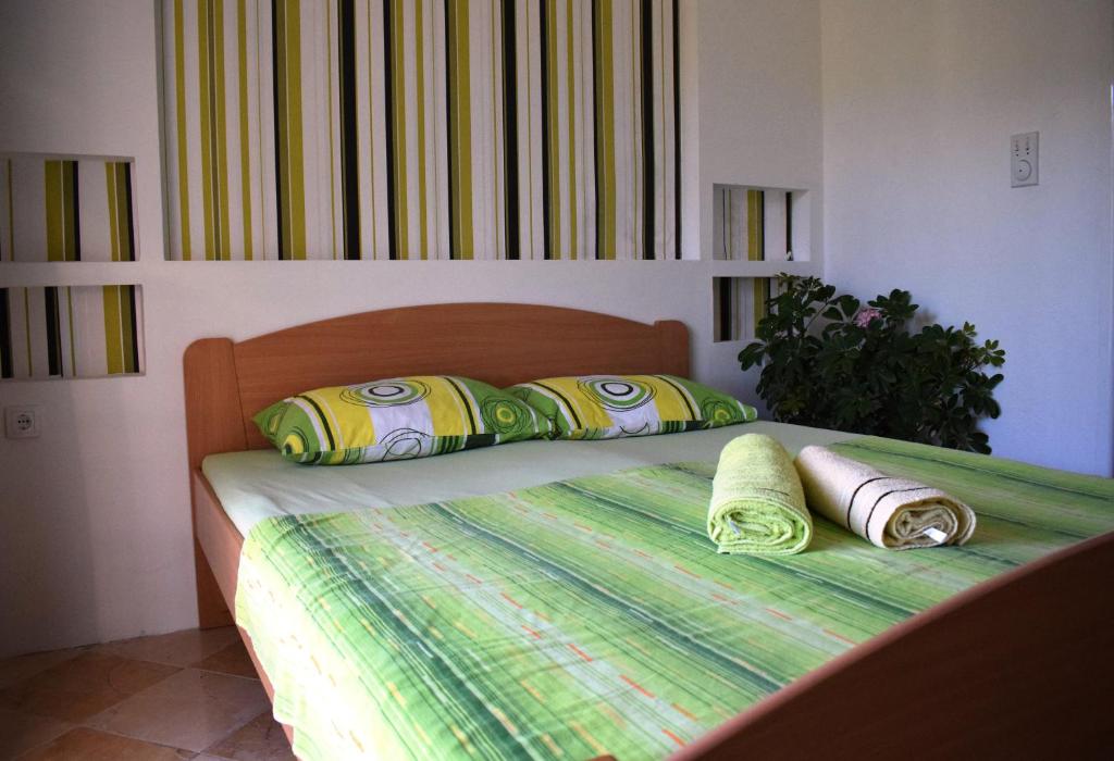 a bedroom with a bed with two pillows on it at Bisha Apartments in Ulcinj
