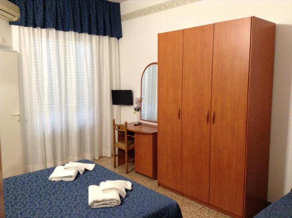 Postel nebo postele na pokoji v ubytování Hotel Saponi