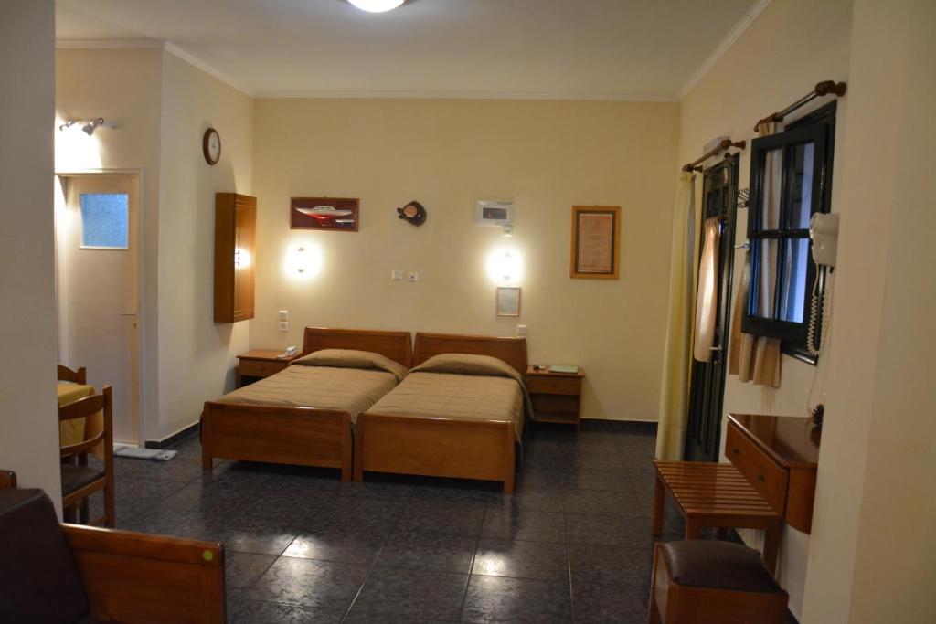 Postel nebo postele na pokoji v ubytování Aristotelis Apartments