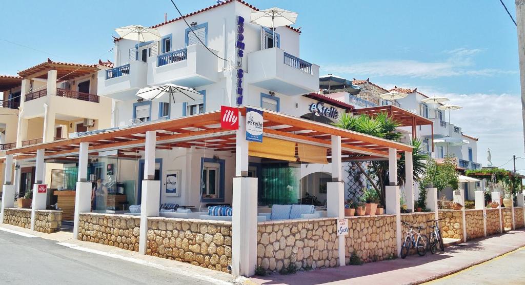 a large white building with awning in front of it at Estella Studios in Elafonisos