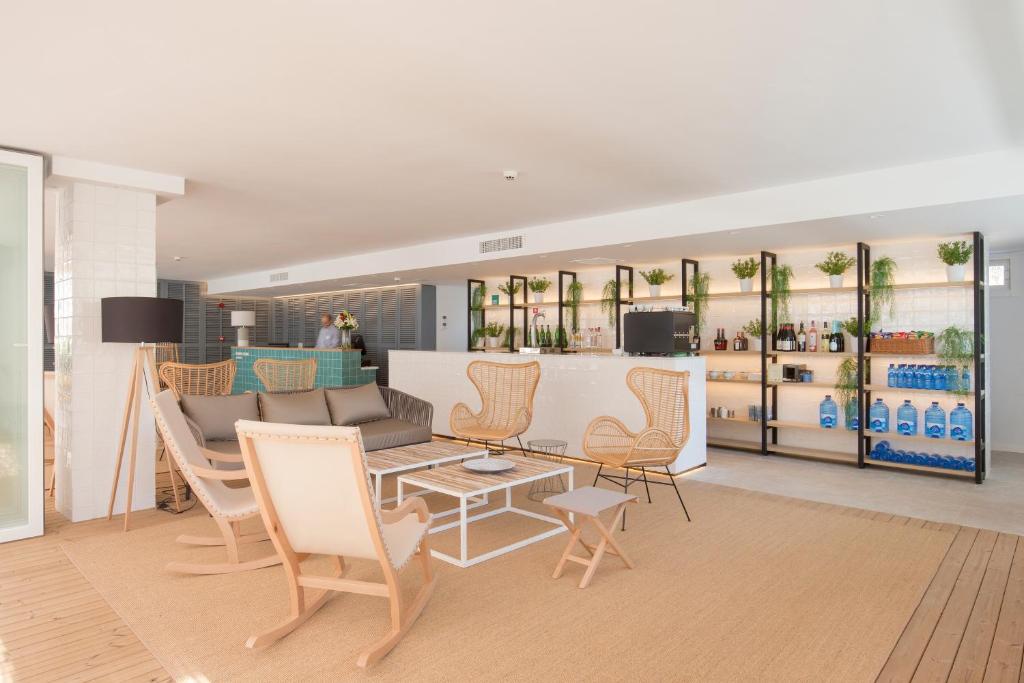 a living room with a couch and chairs at Cabot Hobby Club Apartments in Port de Pollensa