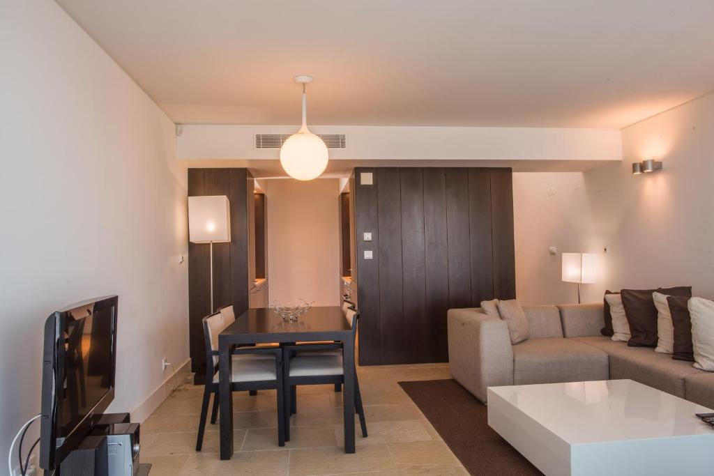 a living room with a couch and a table at Troia Residence by The Editory - Apartamentos Marina in Troia