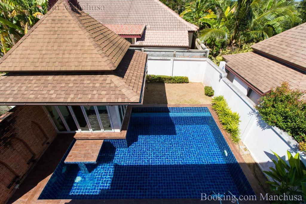 an aerial view of a house with a swimming pool at BaanManchusa Thai Villa in Rawai Beach