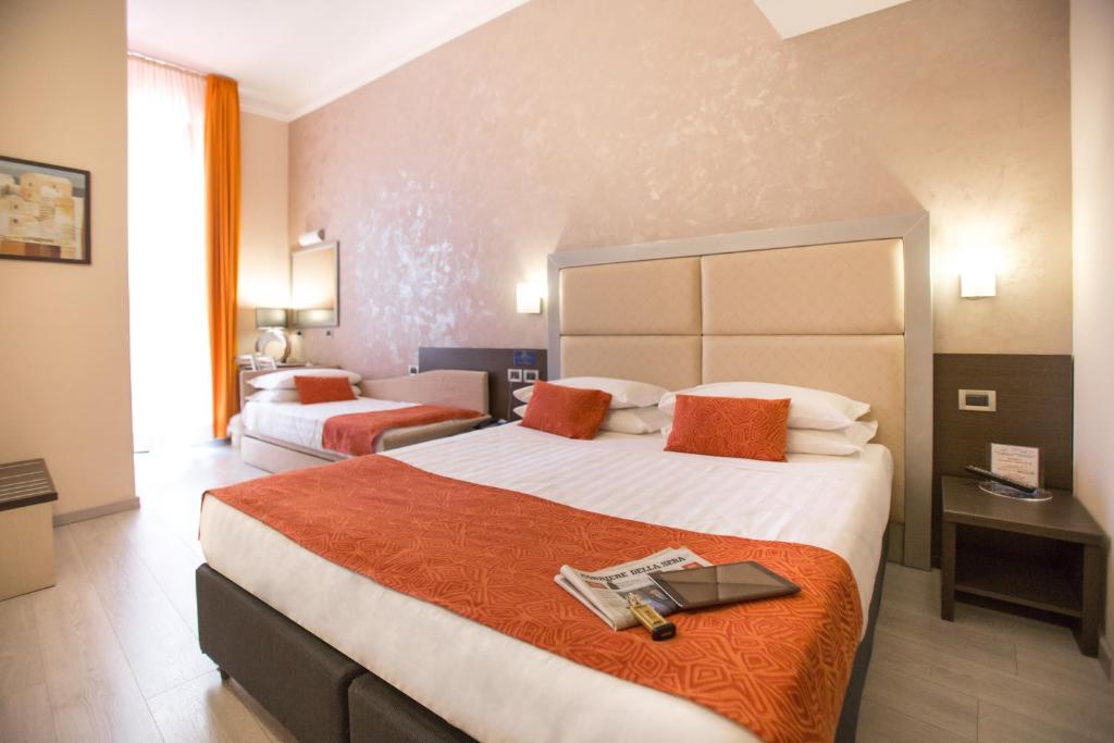 Postel nebo postele na pokoji v ubytování Hotel Piacenza