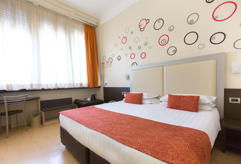 Postel nebo postele na pokoji v ubytování Hotel Piacenza