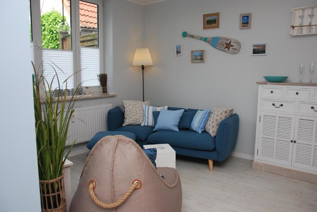 a living room with a couch and a blue sofa at Meine ECKE 2 in Eckernförde