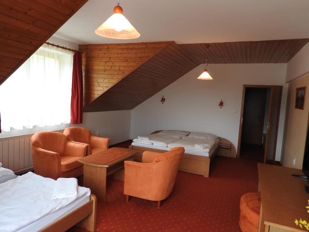 A bed or beds in a room at Penzion Montana