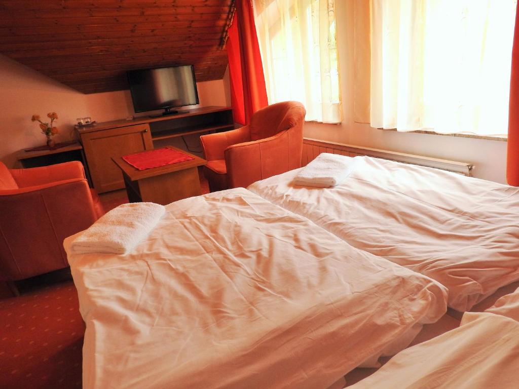 A bed or beds in a room at Penzion Montana