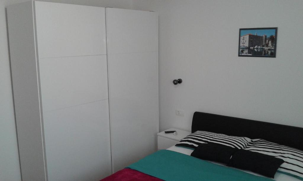 Postel nebo postele na pokoji v ubytování Apartmani Jukic