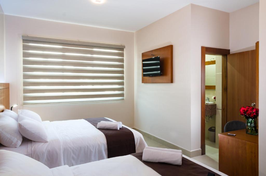Postel nebo postele na pokoji v ubytování Hotel La Ría Durán