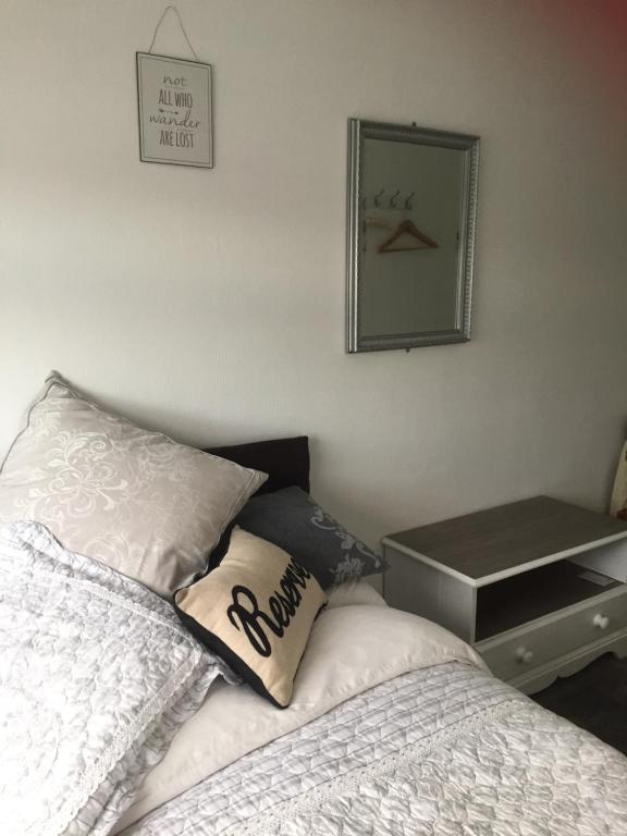 a bed in a bedroom with a lamp on top of it at Southend Airport Bed & Breakfast in Rochford