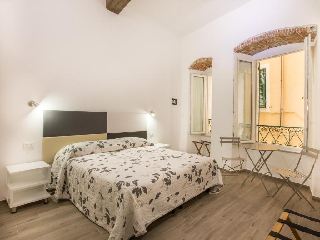 a bedroom with a bed and a table and a window at Marymar in Monterosso al Mare