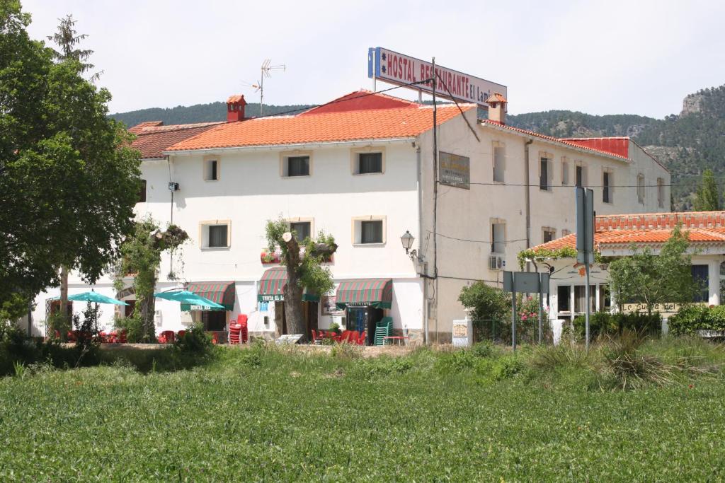 a white building with a sign on top of it at Venta El Laminador in Riópar