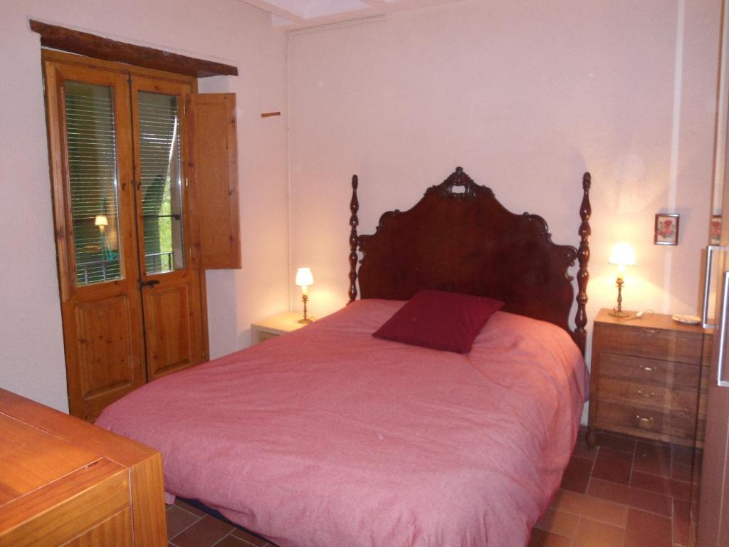 a bedroom with a large bed and two night stands at Cal Son in Alpens