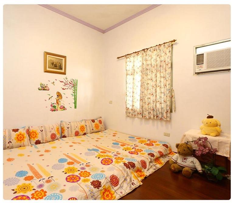 a bedroom with a bed and a teddy bear at Yilan Xiang Feng Homestay in Wujie