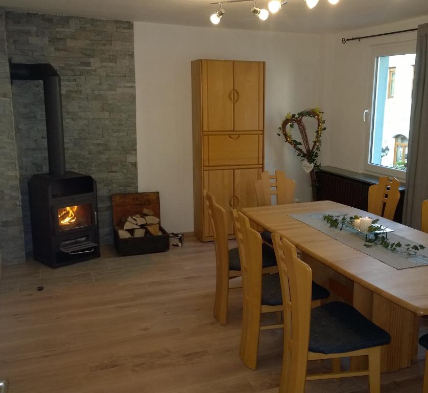 een woonkamer met een houten tafel en een houtkachel bij Ferienwohnung Kylltal in Birresborn