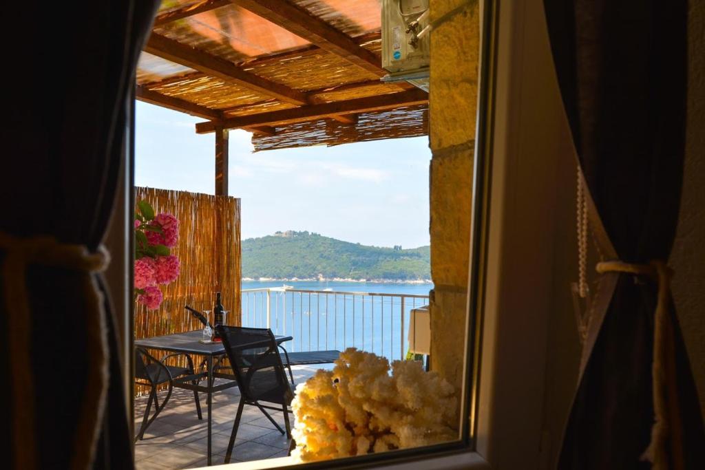 a view from a window of a patio with a table at Apartment and room Sveti Jakov in Dubrovnik