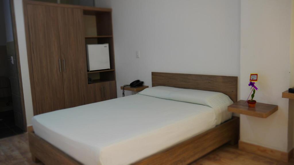 Postel nebo postele na pokoji v ubytování Hotel Barbacoa Uraba