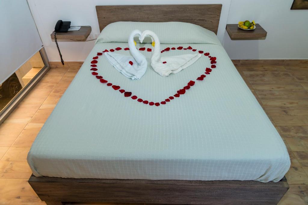 Postel nebo postele na pokoji v ubytování Hotel Barbacoa Uraba