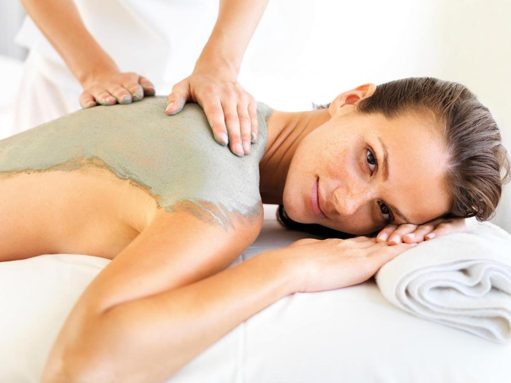 a woman getting a massage from a therapist at Hotel Neptun in Warnemünde