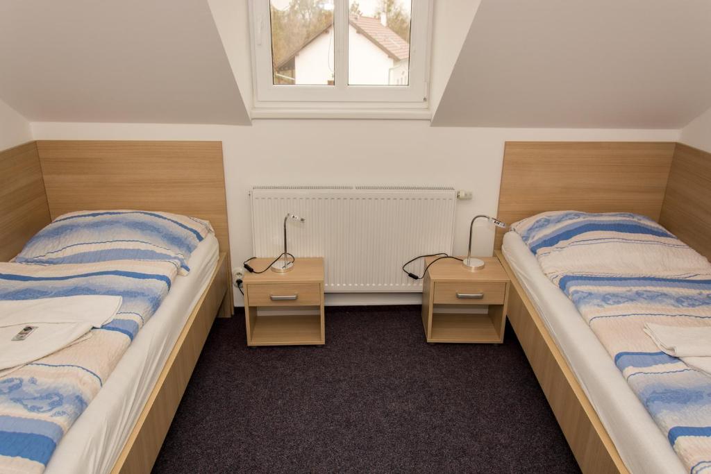 Postel nebo postele na pokoji v ubytování Penzion Harmonie