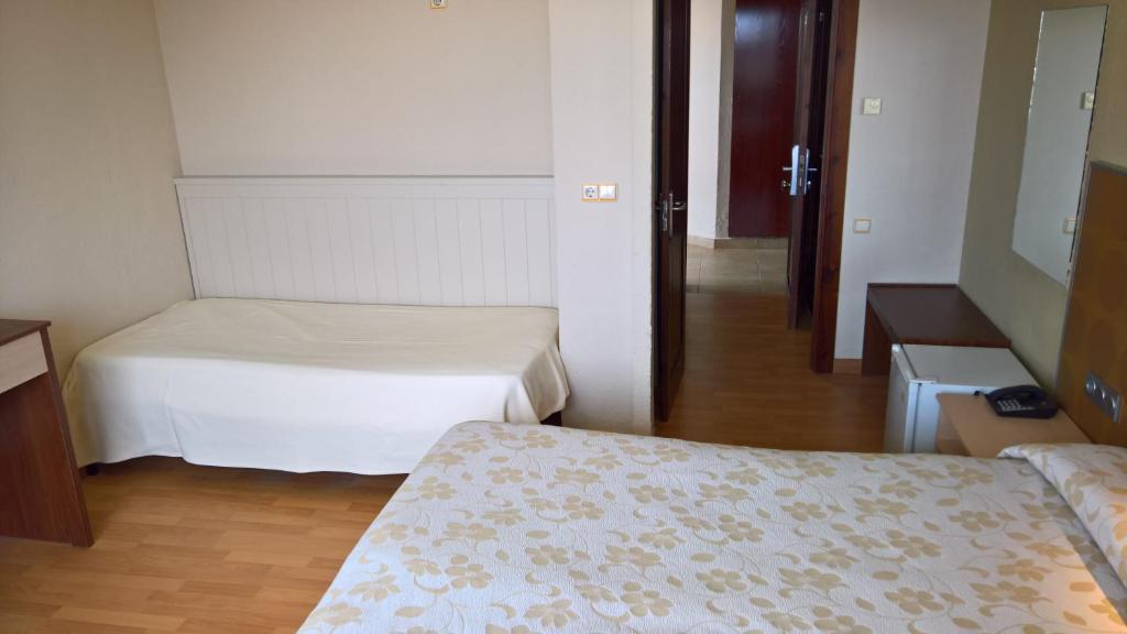 Postel nebo postele na pokoji v ubytování Hotel Flamero