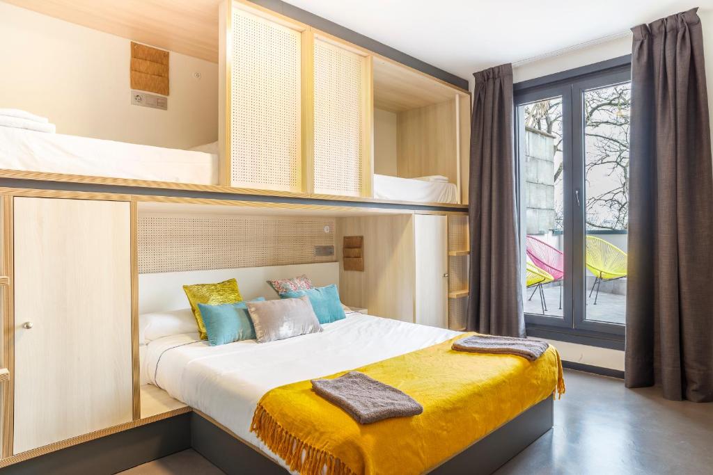 1 dormitorio con 1 cama y literas en Koisi Hostel, en San Sebastián