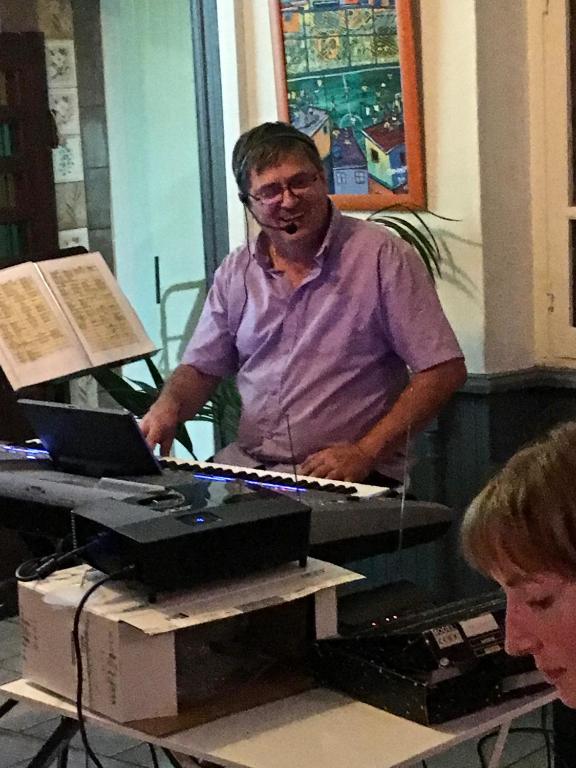 a man sitting at a table with a keyboard at Chambres d&#39;Hôtes Villa Bellevue in Albi