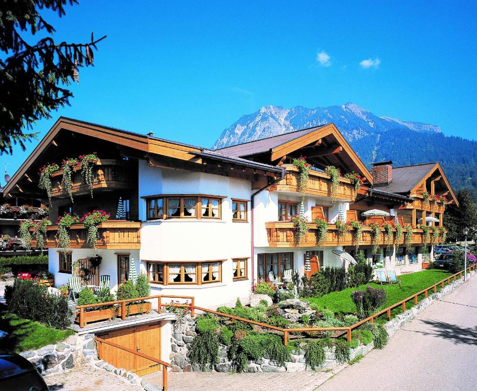 a large building with potted plants on it at Landhaus Bauer in Oberstdorf