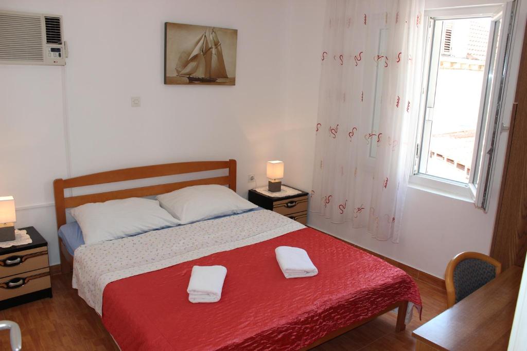 a bedroom with a bed with two towels on it at Guest House Dada in Dubrovnik