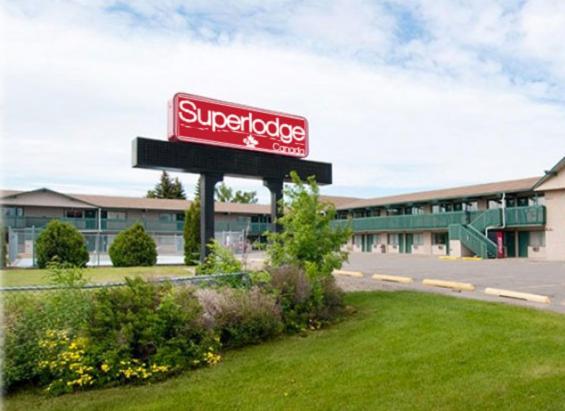 um sinal de superloja em frente a um edifício em Superlodge Canada em Lethbridge