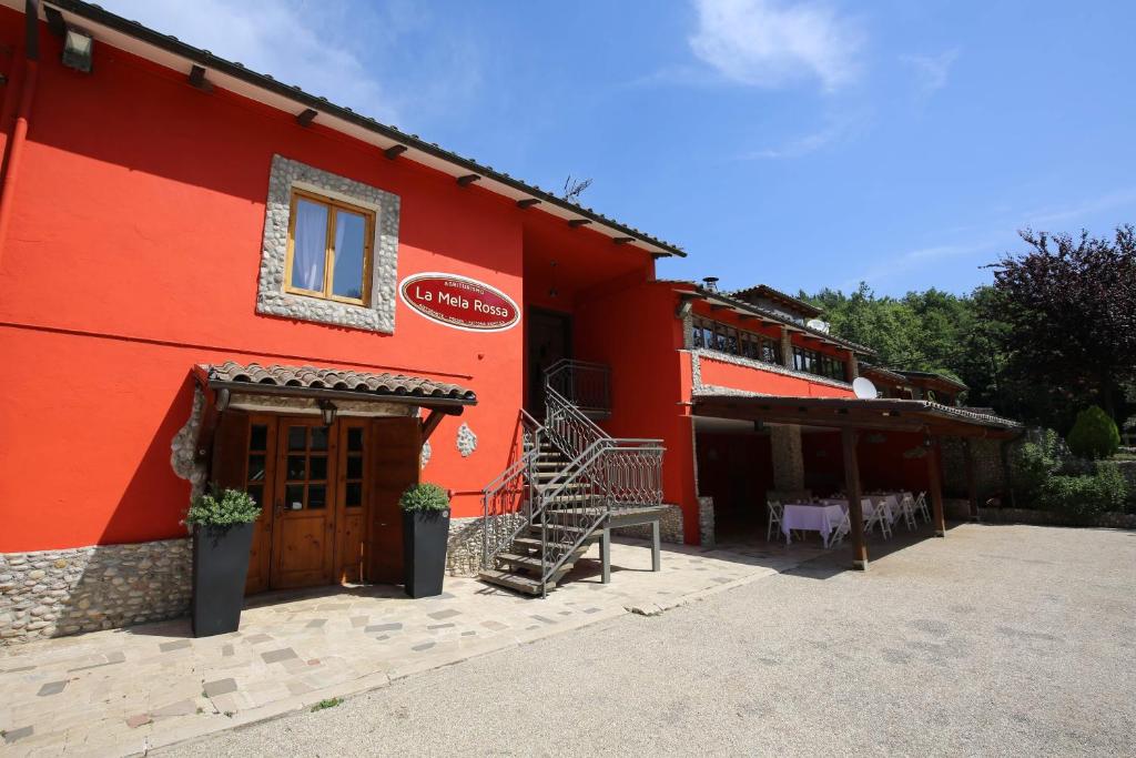 a red building with a staircase in front of it at La Mela Rossa in Terni