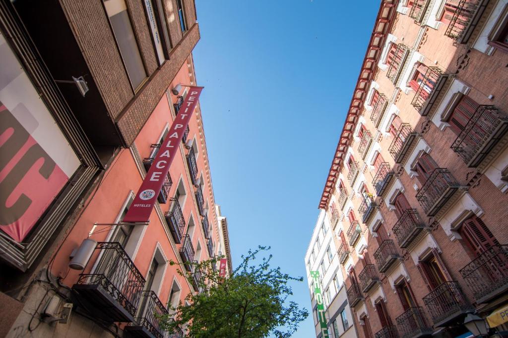 two tall buildings are next to each other at Petit Palace Tres Cruces in Madrid