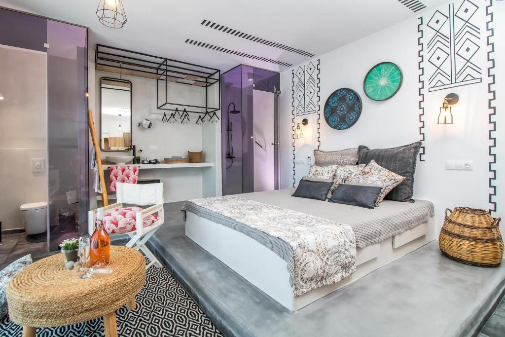 a bedroom with a large bed and a table at Len Art Selected Studios in Faliraki